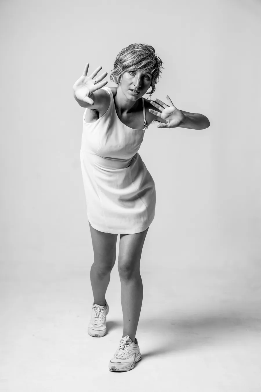 ZOE from Earth in black and white, leaning in with both hands out